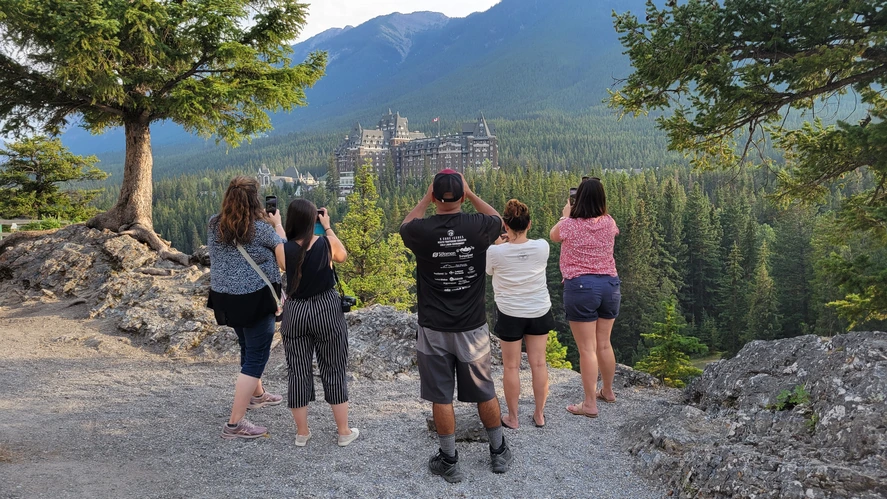 Shot at Sulphur Mountain Two people in winter clothing with snowy mountains in the background.
